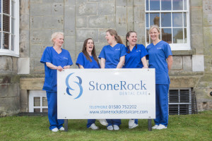 StoneRock staff standing behind sign